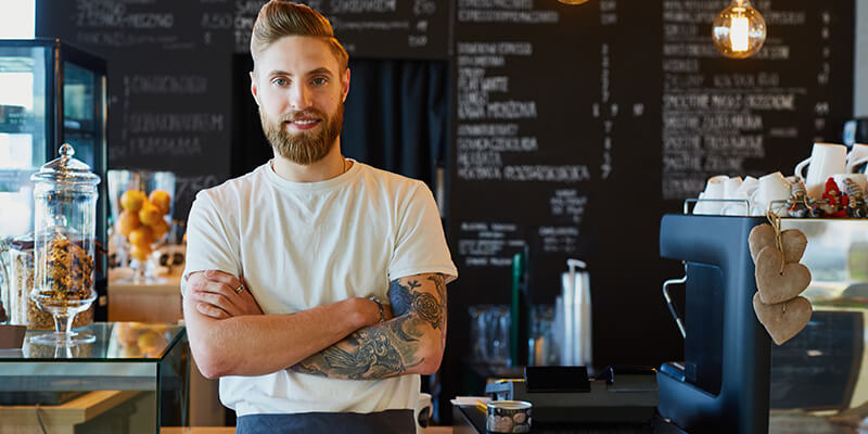 Coffee store employee standing at counter
