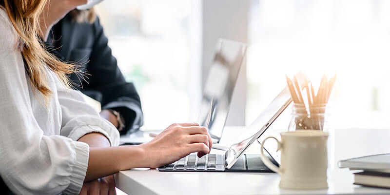 Business meeting with employees using laptops