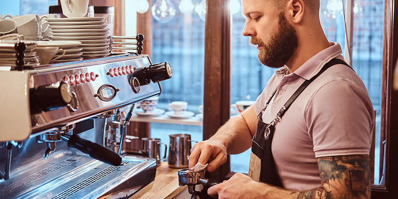 Coffee shop employee brewing coffee