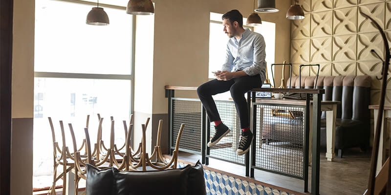 Business owner standing in closed restaurant