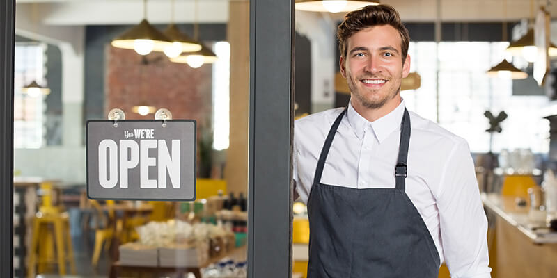 Business owner with an open sign