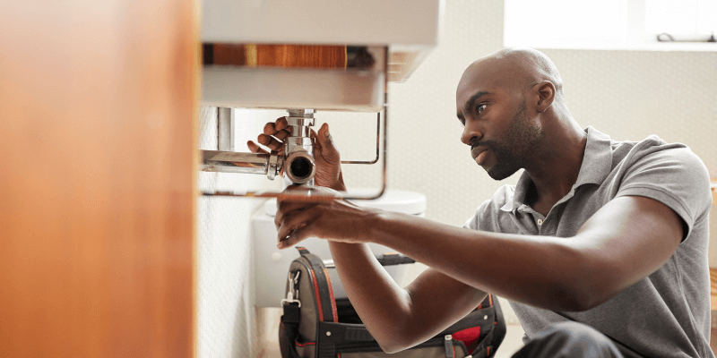 Plumbing contractor fixing sink