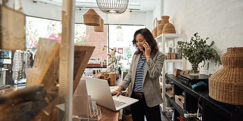 Business owner of retail shop on phone with customer