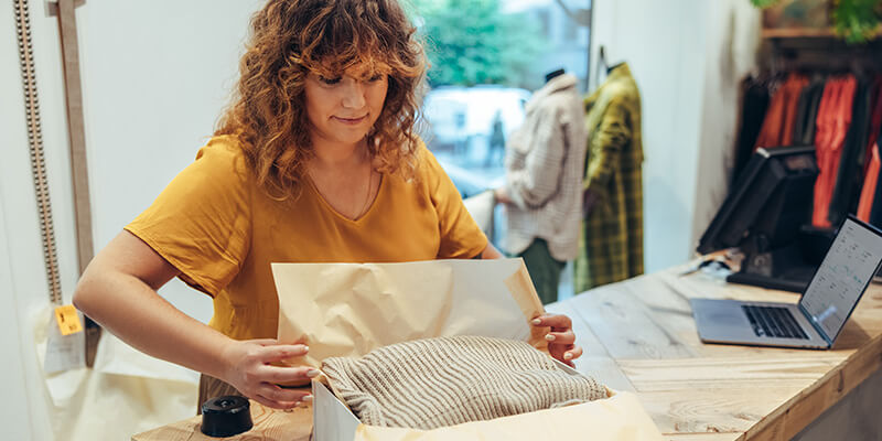 Retail employee packaging a purchase