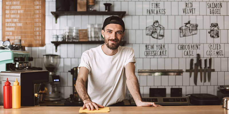 Cafe employee standing at countertop